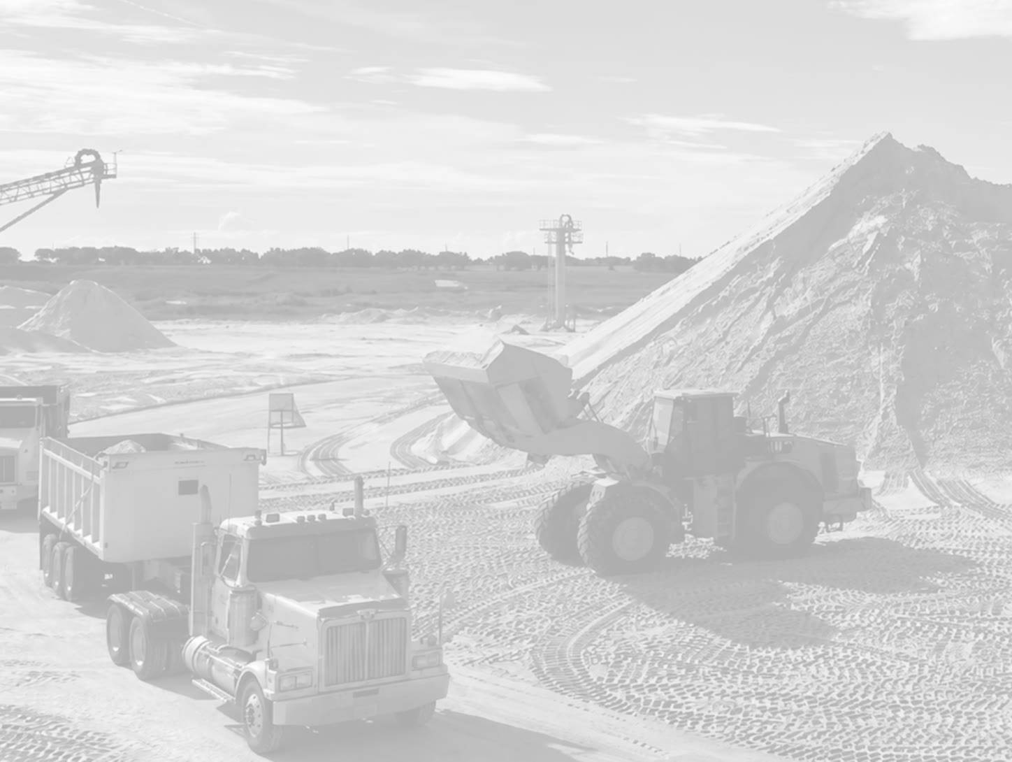 Bulk material haulage truck and loader at an aggregate site